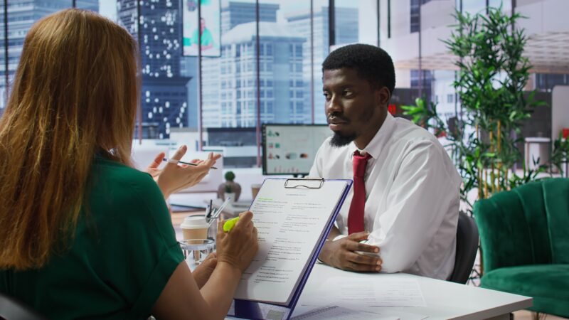 Professional recruiter reviewing resumes during a jobs and recruitment process