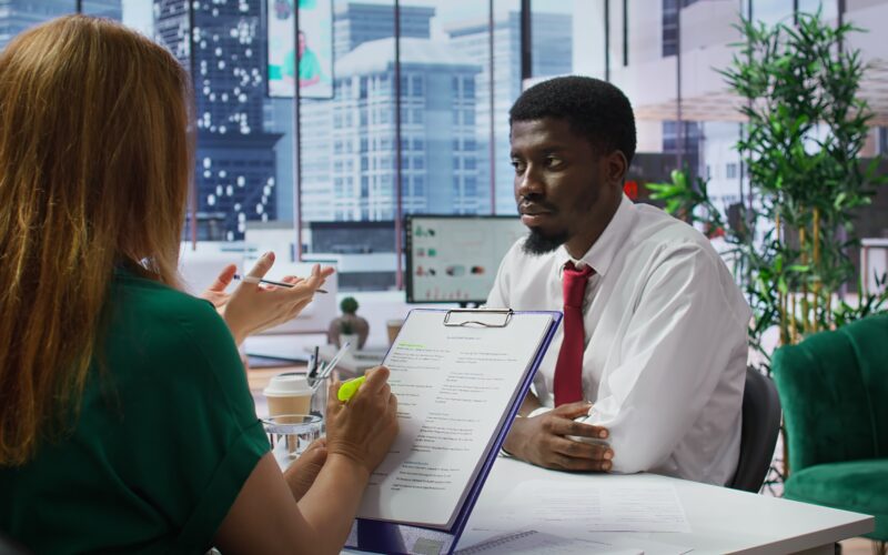 Professional recruiter reviewing resumes during a jobs and recruitment process
