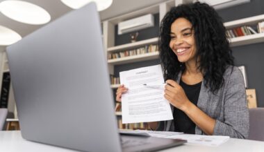 Young professional submitting an employment job application online using a laptop.