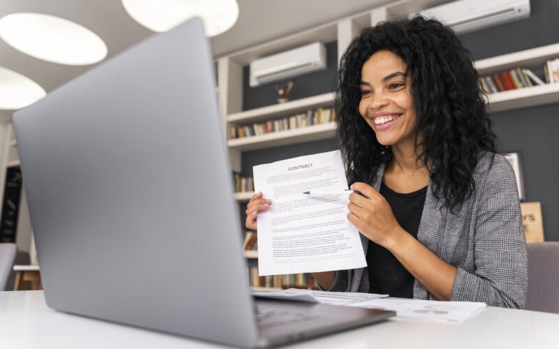 Young professional submitting an employment job application online using a laptop.