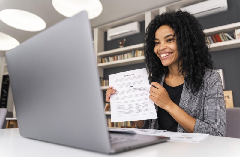 Young professional submitting an employment job application online using a laptop.